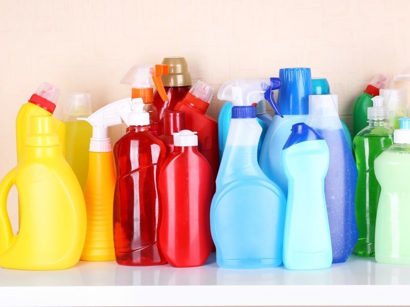 yellow red blue green and purple cleaning product bottles