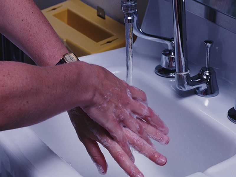 woman washing her hands at sink